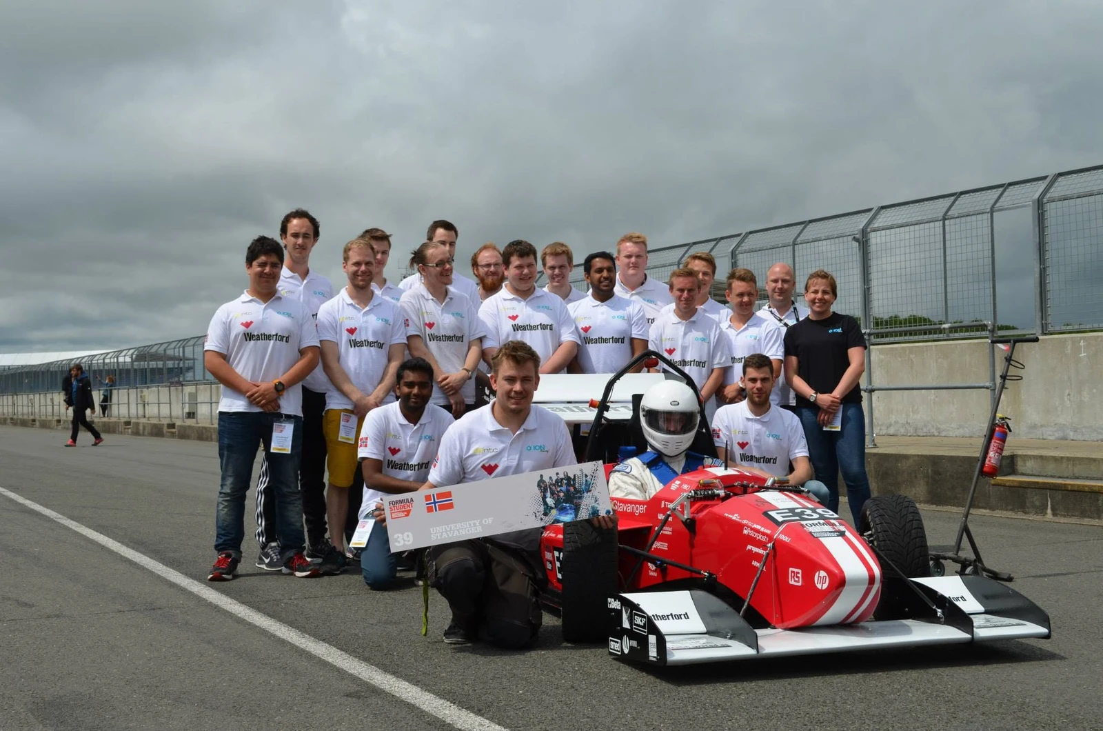The Formula Student team gathered around their race car at Silverstone.