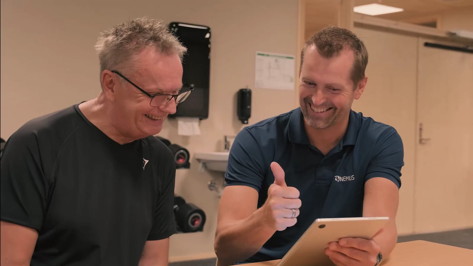 A participant and a clinician review a tablet together.