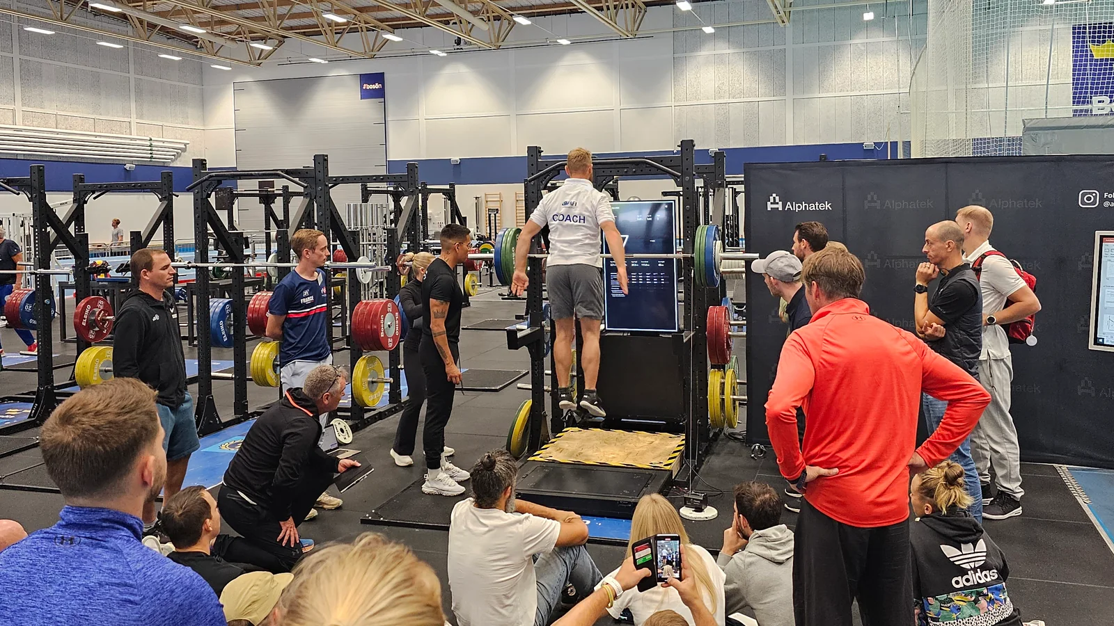 A group watches a demonstration of a jump on the Alphatek platform.